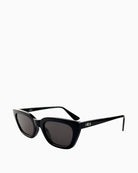 Side view of Otra Nove sunglasses showing sleek black finish and vegan pouch