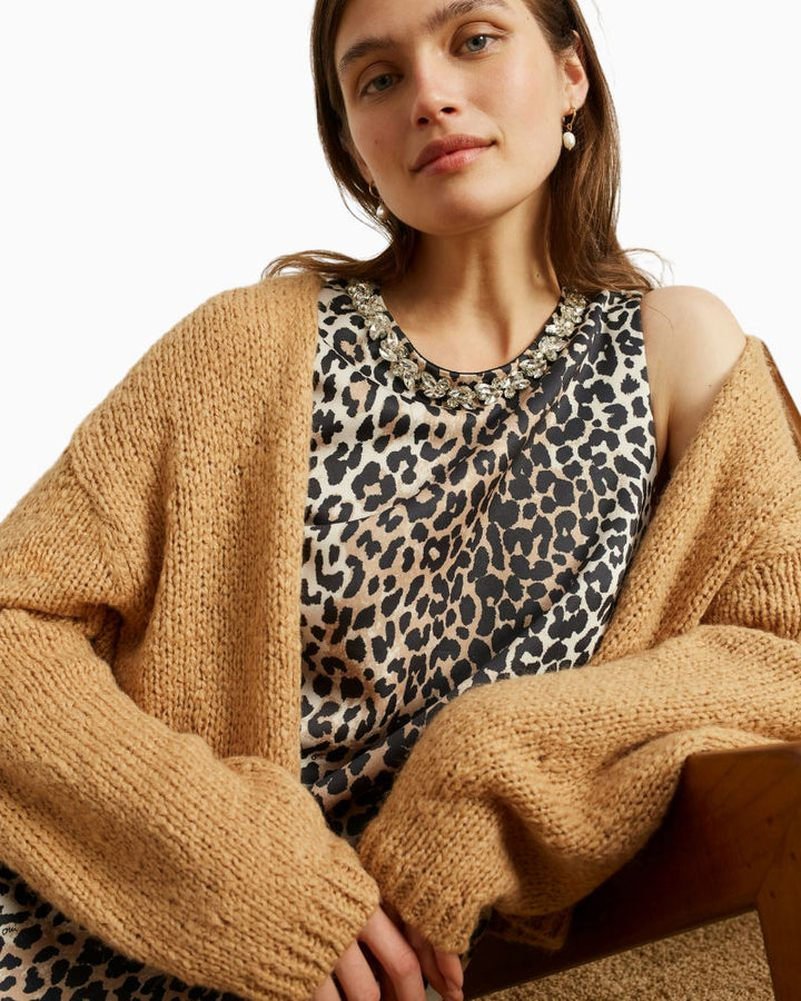 Close-up of soft scuba fabric and decorative stone detail at neckline