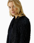 Close-up of fringe and lustre detailing on Oui black occasion jacket