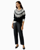 Side view of black knit jumper showing relaxed fit and ribbed hem