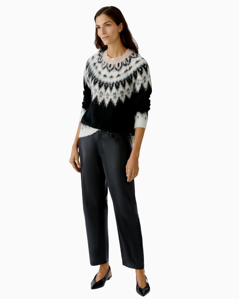 Side view of black knit jumper showing relaxed fit and ribbed hem