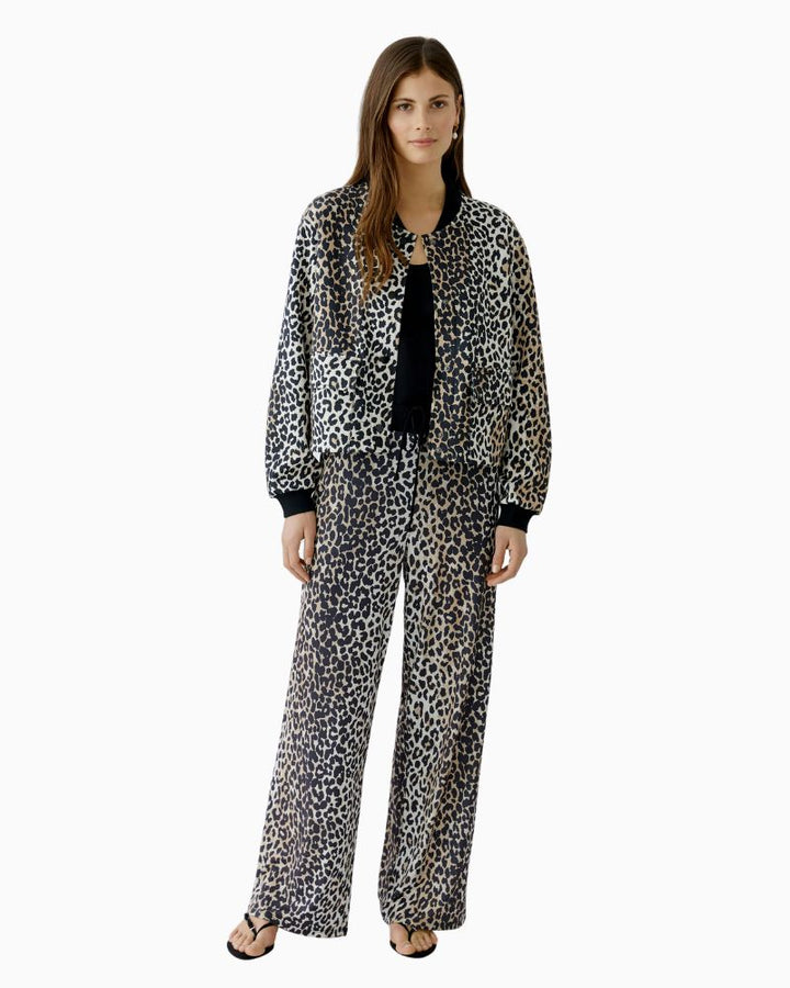 Model view of relaxed O-shape jacket showing stretch cuffs and soft scuba texture