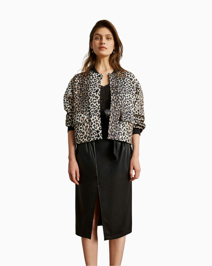 Side view of relaxed O-shape jacket showing stretch cuffs and soft scuba texture