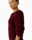 Close-up of round neckline and ribbed hem detail