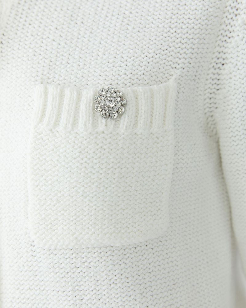 Close-up of Cloud Dancer cardigan showing decorative buttons and ribbed trim