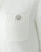 Close-up of Cloud Dancer cardigan showing decorative buttons and ribbed trim