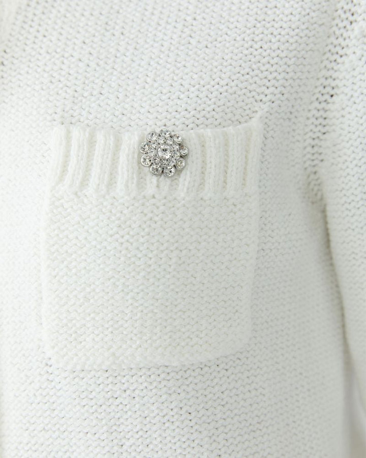 Close-up of Cloud Dancer cardigan showing decorative buttons and ribbed trim