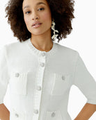 Close-up of Cloud Dancer cardigan showing decorative buttons and ribbed trim
