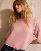 Woman wearing Oui dusty rose oversized pullover, styled front view – Áines Boutique