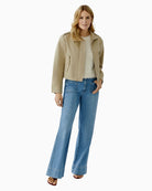 Woman wearing Oui sand jacket with denim, full outfit model view – Áines Boutique