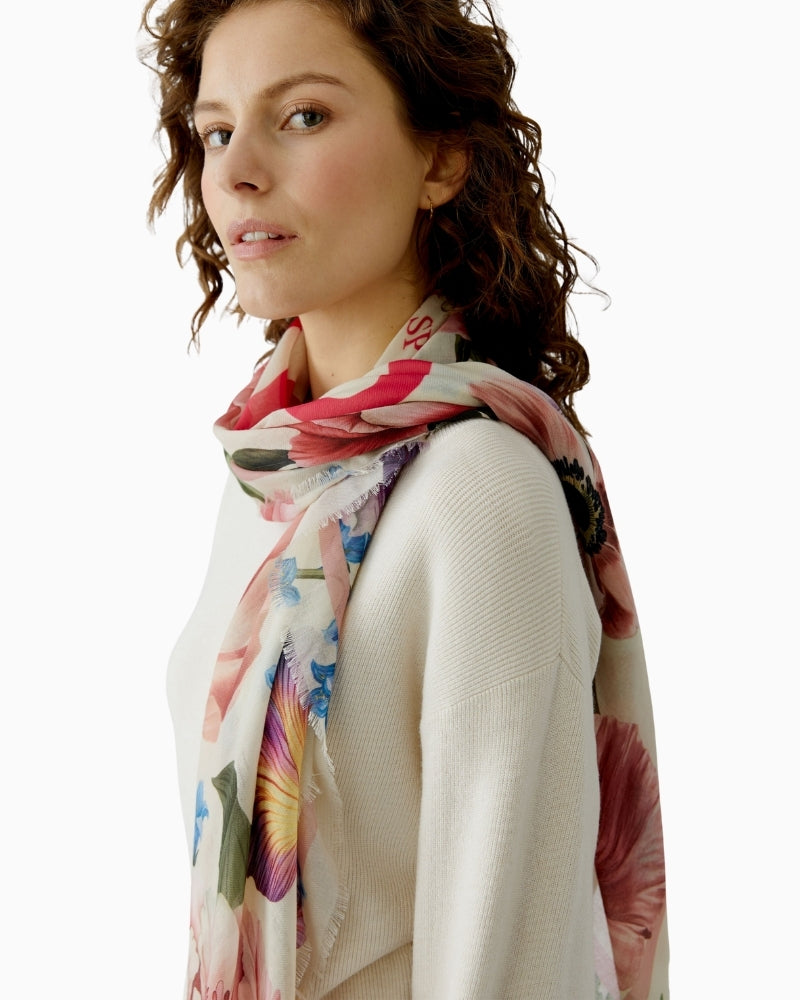 Woman wearing Oui rose red floral shawl draped over shoulders – Áines Boutique