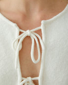 Close-up of tubular hem neckline and fine knitted cuffs