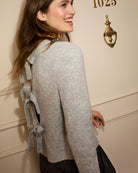 Close-up of ribbed cuff and sleeve detail on soft grey knit