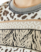 Detail of lustre yarn in jacquard knit pattern on black and off-white Oui sweater