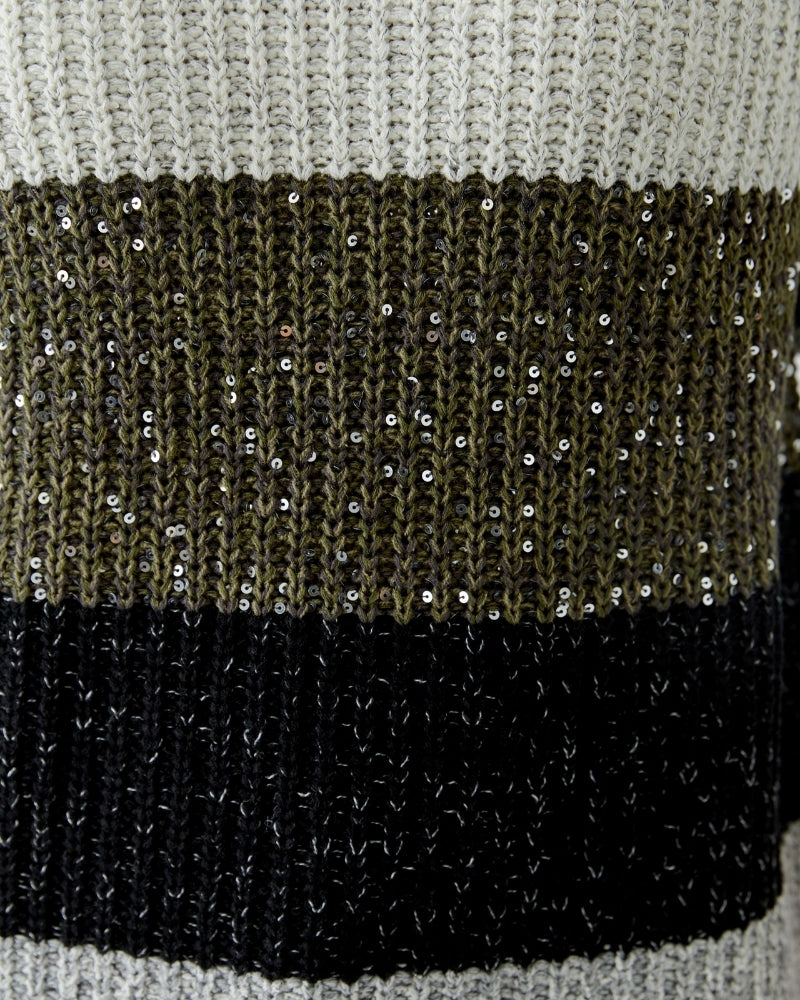 Close-up of knit texture with hint of metallic thread woven through