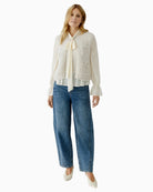 Oui knit vest styled over blouse for smart layering look