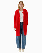Red Oui coat styled casually over knitwear and trousers