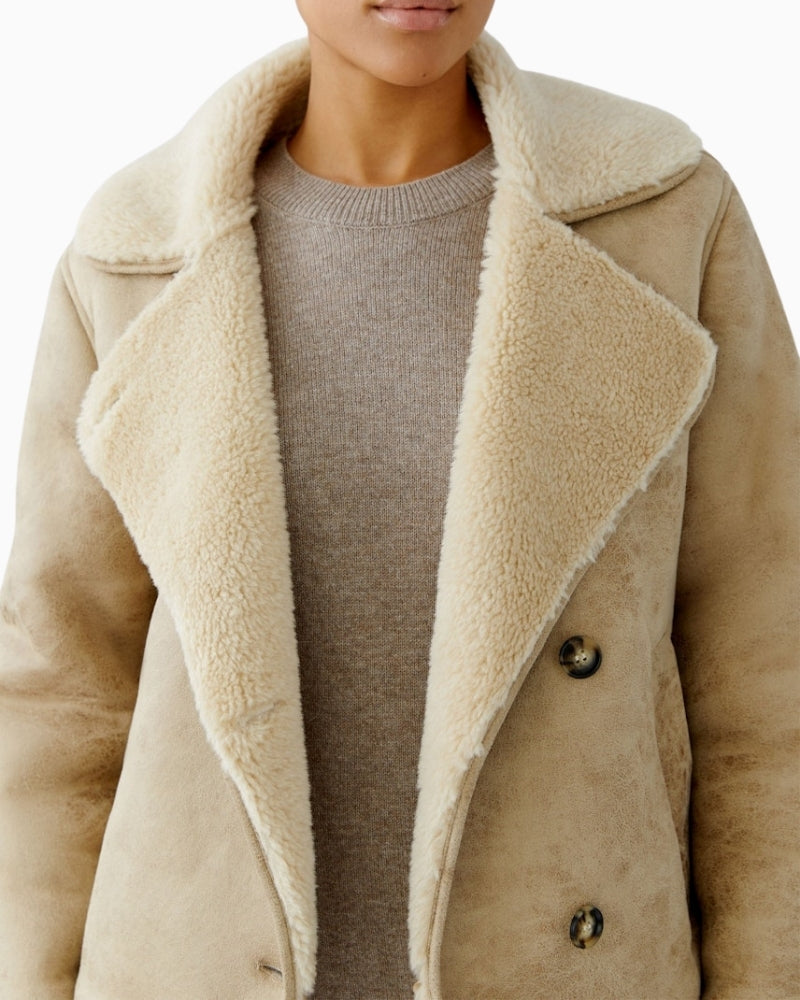 Close-up of woven fur lining and adjustable cuff detail on Oui outdoor jacket