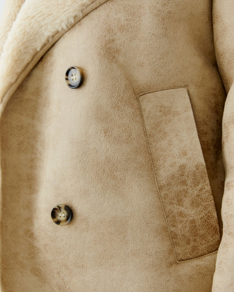 Close-up of woven fur lining and adjustable cuff detail on Oui outdoor jacket