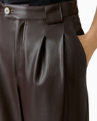 Close-up of waistband with belt loops and pleat detail on Oui trousers