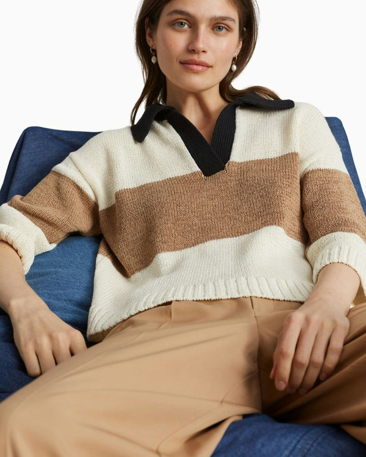 Close-up of waistband, pleats, and soft drape of twill fabric