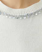 Close-up of ribbed cuff and faux pocket detail on soft knit