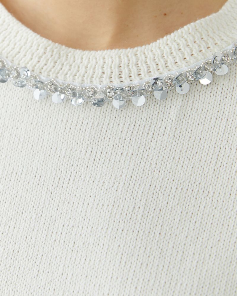 Close-up of ribbed cuff and faux pocket detail on soft knit