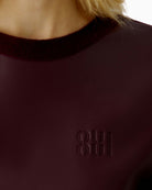 Close-up of ribbed neckline and Milano-knit sleeve on Oui bramble berry pullover