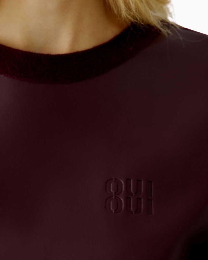 Close-up of ribbed neckline and Milano-knit sleeve on Oui bramble berry pullover