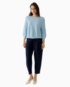 Woman wearing Oui light blue oversized ribbed pullover with trousers, full outfit view – Áines Boutique