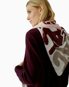 Close-up of rose red shawl showing lightweight fabric and vibrant print