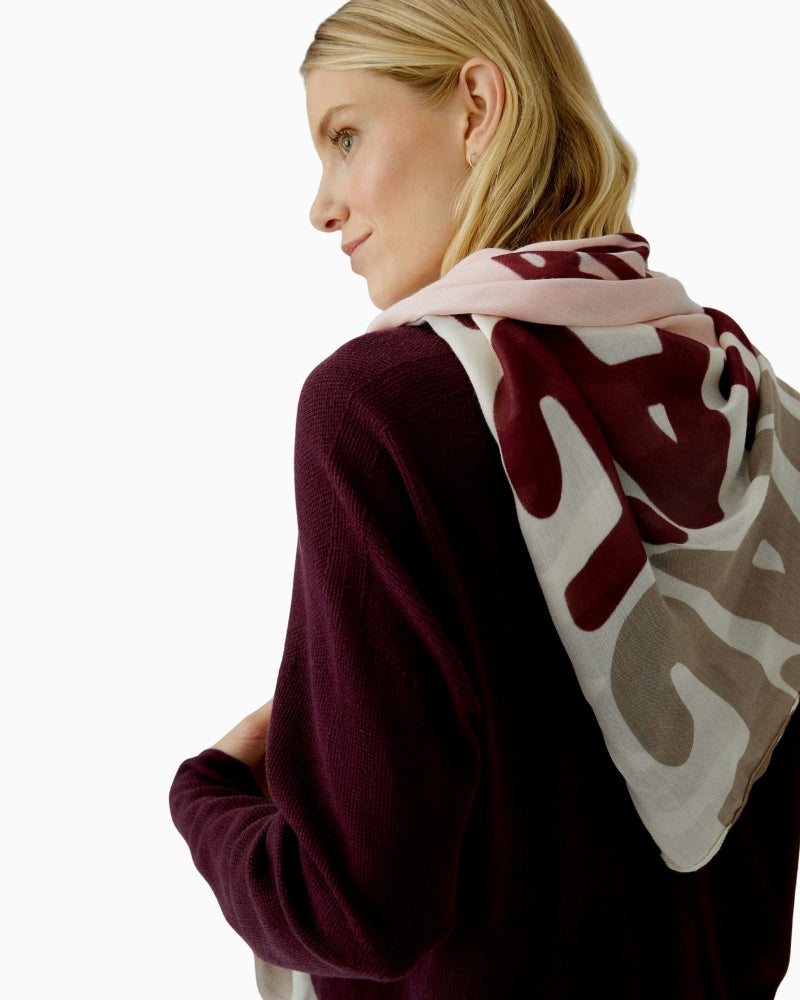 Close-up of rose red shawl showing lightweight fabric and vibrant print