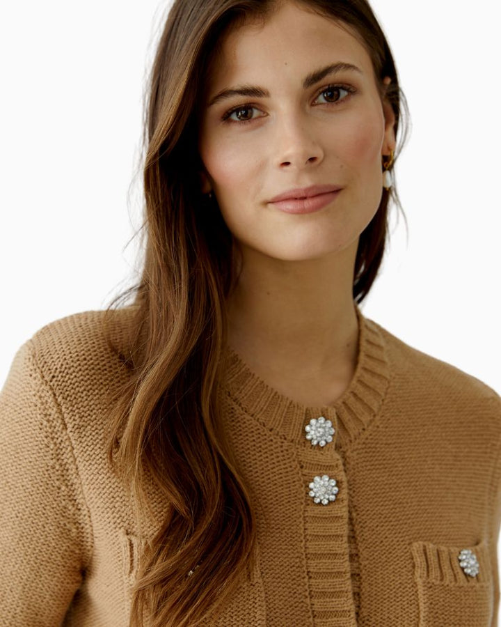 Close up of Cropped textured knit cardigan with round neck and decorative buttons