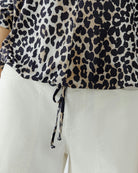 Close-up of silky leopard print fabric in camel and black