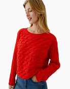 Side view of cropped red jumper with rolled sleeve cuffs