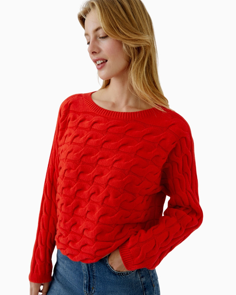 Side view of cropped red jumper with rolled sleeve cuffs