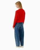 Back view of red cable knit jumper showing neat finish