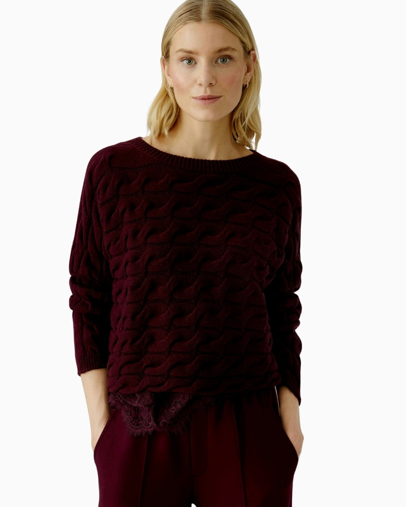 Side view of boxy Oui pullover showing relaxed sleeve and ribbed cuff details