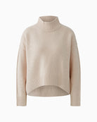 Front view of relaxed pink jumper with dropped shoulders and wide cuffs