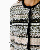 Close-up of textured knit and button detailing on Oui jacket