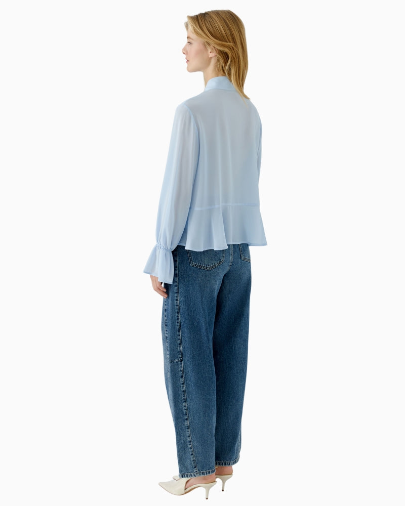 Back view of flowy blue polyester blouse with smooth finish