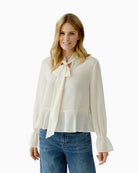 Off-white blouse with tie-knot collar in soft draping fabric