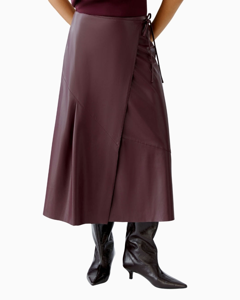 Front view of Oui wrap skirt in bramble berry with leather-look fabric and midi length