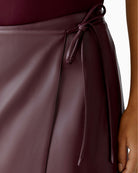 Close up of Oui leather-look wrap skirt styled with knit jumper and ankle boots for autumn
