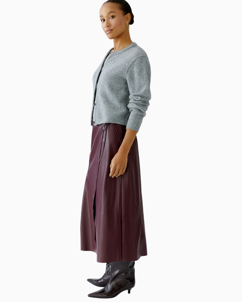 Side view of A-line midi skirt showing tie fastening and soft bonded texture