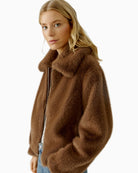 Side view of taupe faux fur jacket with cropped cut and knitted cuffs