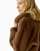 Close-up of knitted cuff detail on Oui taupe faux fur jacket