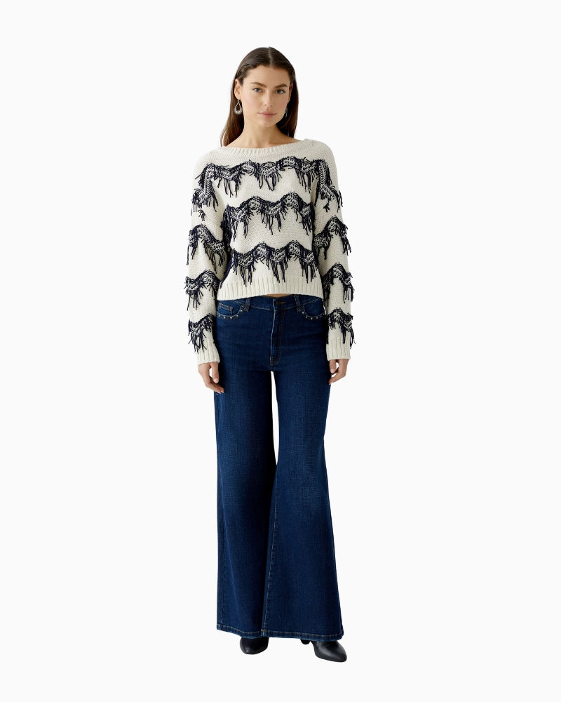 Model wearing pullover with jeans, showcasing dropped shoulders