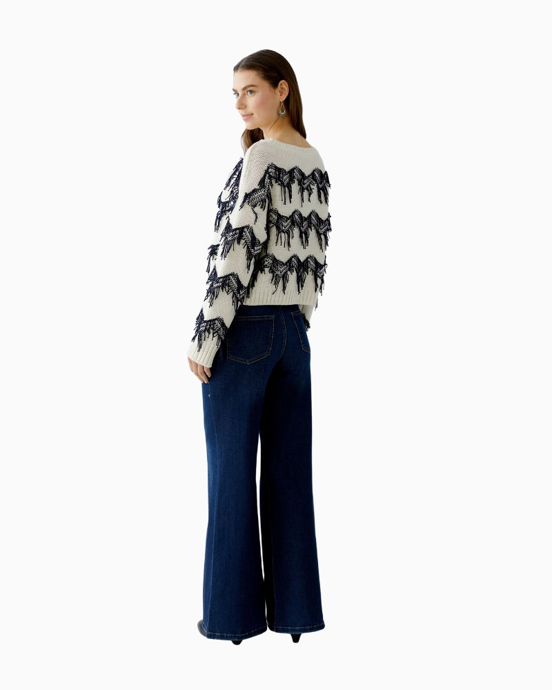 Back view of fringe detailing on sleeve and shoulder
