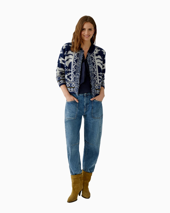Model wearing cardigan over tee and jeans for casual styling